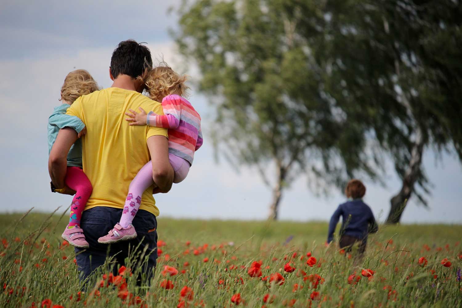 Père tenant ses enfants dans les bras